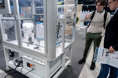 automated programmed robotic arm for manufacturing and industrial lines conveyor belts, technology exhibition, Warsaw, 2024-05-16. High quality photo