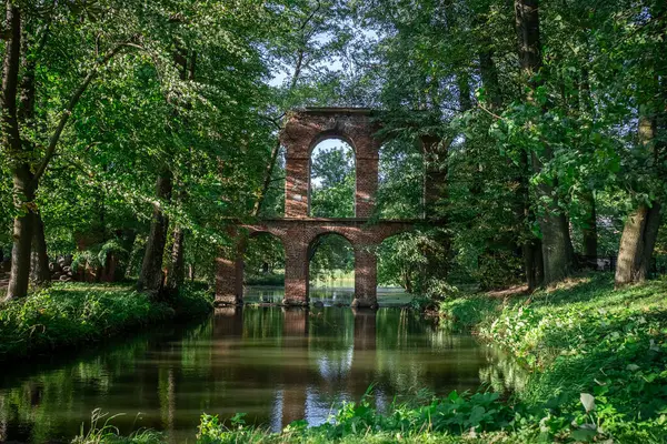 stock image old ancient aqueduct in romantic Arcadia park, antique Roman architecture made of brick wall, historical building, Poland. High quality photo