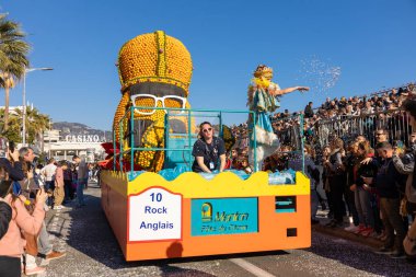 Menton, France-February 12, 2023:traditional carnival parade of Lemon Festival in colorful costumes and big carnival floats with big figures from lemons and oranges