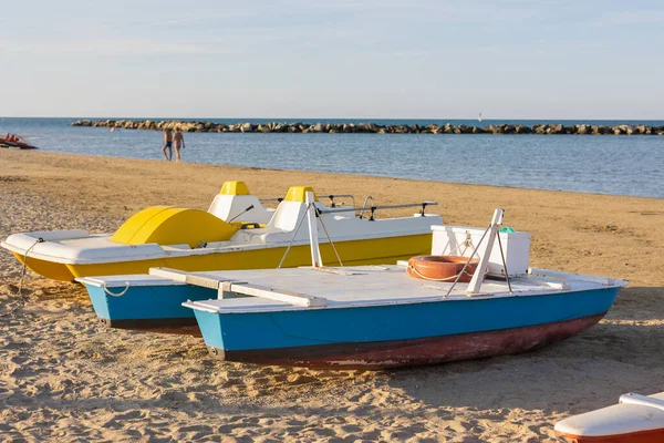 stock image One yellow old vintage plastic catamaran and wood boat shore of sea for water activities during the holidays and vacation.