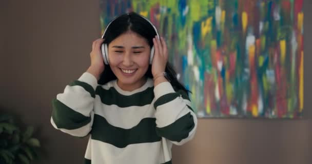 Young Woman Listens Music Wireless Headphones While Nodding Rhythm Song — Stockvideo