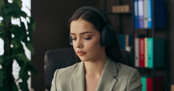 Calm Adorable Beautiful Young Woman Wears Wireless Headphones Discussing Project — Video