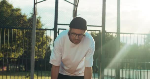 Handsome Hipster Fashionable Sportswear Shows Skills Camera Stands Playground Scores — Vídeo de stock