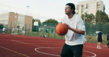 Men play basketball game on sunny day. Men practice basketball skills at playground. Happy friend spend time together at weekend competition concept.