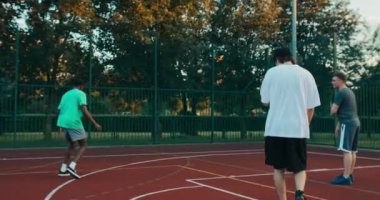 African american black guy basketball player showing skills plays basketball with friends trining. Friendship reunion at weekend.