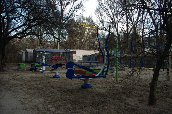 Old playground in winter. Attractions for children. Swings and slides for fun in winter. For a walk in the fresh air