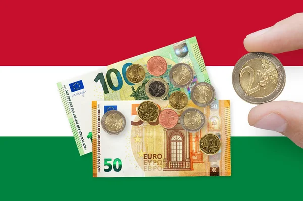 Currency of European Union over Hungary Flag. EUR is the official currency of the European Union. The concept of financial crisis and recession