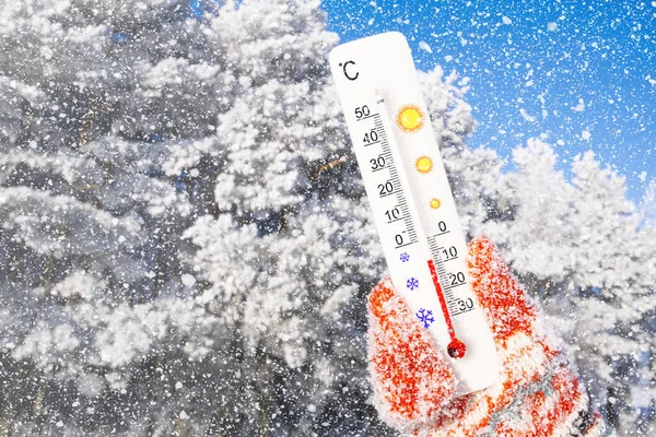 stock image Winter holidays with snow. White celsius scale thermometer in hand. Ambient temperature minus 8 degrees celsius