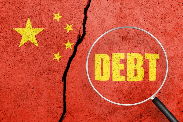 China flag painted on a cracked concrete background. China finance, real estate and debt crisis. China economic collapse. Word DEBT view through magnifying glass