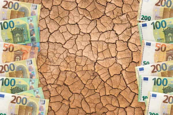 Cracked earth with euros. Global warming, climate change concept. Carbon dioxide emission concept
