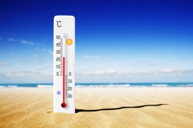 Sıcak yaz günü. Kumda Celsius termometresi var. Çevre sıcaklığı artı 25 derece 