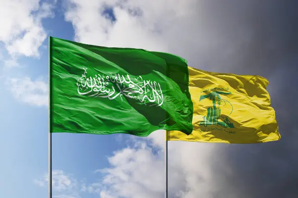 stock image Flags of Hamas and Hezbollah above dark sky