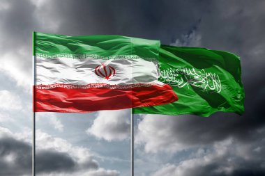 Karanlık gökyüzünün üzerinde İran ve Hamas bayrakları