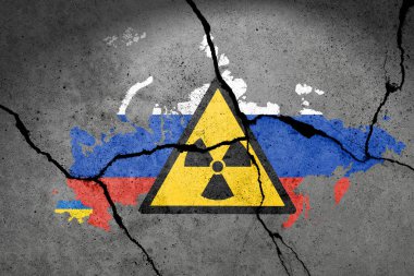 Flag of Ukraine and Russia painted on a concrete wall with atomic bomb sign. Russian military aggression clipart