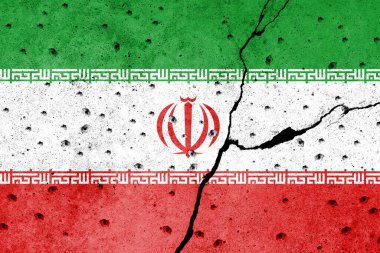 Protestocuların gölgesi altında beton bir duvara İran bayrağı