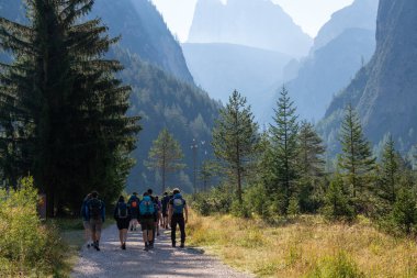 Bir grup turist, sırt çantalı dağcılar sabah erkenden dağlara giderler. Alplerde şafak vakti. Sağlıklı, aktif bir yaşam tarzı. Spor ve zevk. Hayatın neşesi. Güzel doğa. Taşlar. Dolomit.
