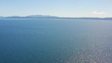 Makarska Hırvatistan yakınlarındaki Mavi Adriyatik Denizi. Ufukta Hvar adasının dağları var. Denizde iki yelkenli ve bir motorlu tekne, yaz güneşli bir gün. Dağdan görünüm