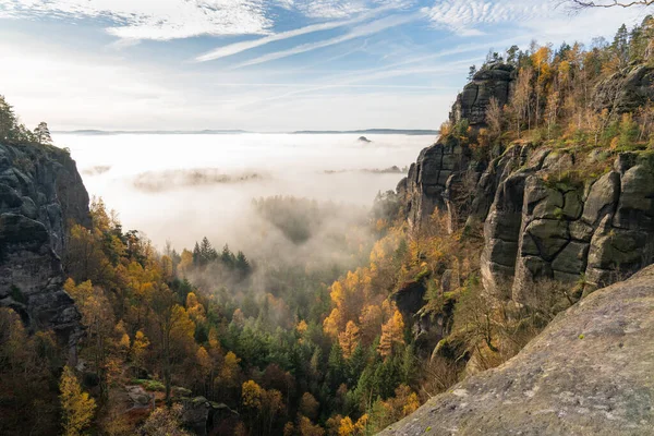 Schrammstein mountains at the elbsadsteingebirge. Autumn landscape. Fog. Blue sky. Saxon Switzerland. Germany