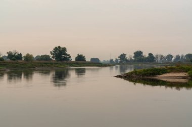 Early morning on the river Elbe near Pretzsch Saxony Germany. Beautiful bends of the river. Green trees . little mist