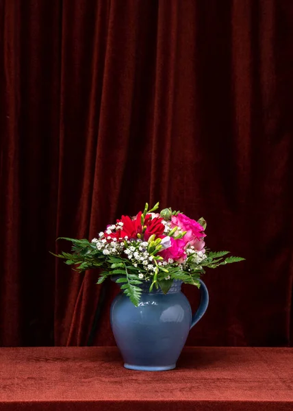 Beautiful bouquet of flowers on a dark fabric background. Space for text, copy space. Still life