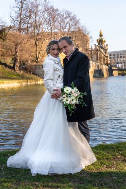 Düğün çifti yürüyüşü. Dresden, Almanya 'daki ünlü Zwinger Sarayı' nın önünde duruyor.