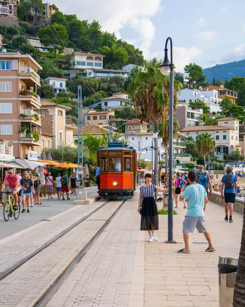 Stock image Port de Soller. Mallorca. Spain. 4.10.2023. The famous orange tram runs from Soller to Port de Soller. Sunny day, lots of tourists