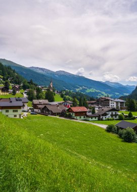  Beautiful village of Heiligenblut in valley among high mountains. Not far from highest mountain Grossglockner and famous grossglockner high alpine road. Austria clipart