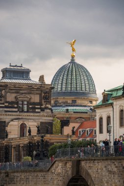 Dresden. Saxony. Germany. 11.10.2020. Many tourists enjoy historical atmosphere on Bruhl Terrace in Dresden.In background is majestic dome of Academy of Art with archeitectural details. clipart