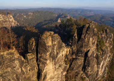 Rock formations in Saxon Switzerland National Park. View of rock formations from  Bastai Bridge. Popular tourist spot. Germany clipart