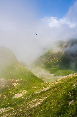 Beautiful mountain scenery , famous winding road Hochalpenstrasse in Austria. Grossglockner High Alpine Road.Clouds descended on the mountains Unique views of Austrian Alps. clipart