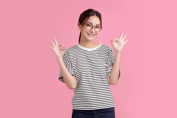 Portrait Happy Asian Woman Shows Sign Looking Camera Pink Background — Stok Foto
