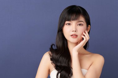 Beautiful young asian woman with clean fresh skin on blue background, Face care, Facial treatment, Cosmetology, beauty and spa, Asian women portrait.