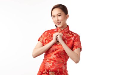 Happy Chinese new year, Beautiful young Asian woman wearing traditional cheongsam qipao dress with gesture of congratulation isolated on white background.