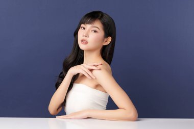 Beautiful young asian woman with clean fresh skin on blue background, Face care, Facial treatment, Cosmetology, beauty and spa, Asian women portrait.