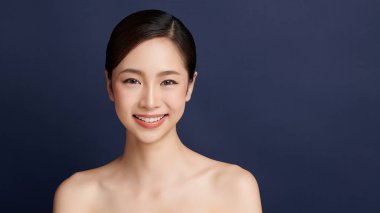 Beautiful young asian woman with clean fresh skin on blue background, Face care, Facial treatment, Cosmetology, beauty and spa, Asian women portrait.