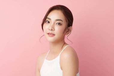 Pembe arka planda temiz tenli güzel Asyalı kadın, yüz bakımı, yüz bakımı, kozmetoloji, güzellik ve kaplıca, Asyalı kadın portresi.