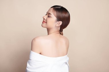 Güzel, genç Asyalı bir kadın bej arkaplan, yüz bakımı, kozmetik, güzellik ve kaplıca, Asyalı kadın portresi.