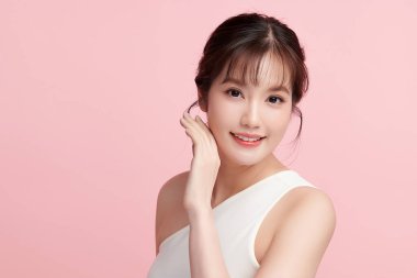 Pembe arka planda temiz tenli güzel Asyalı kadın, yüz bakımı, yüz bakımı, kozmetoloji, güzellik ve kaplıca, Asyalı kadın portresi.