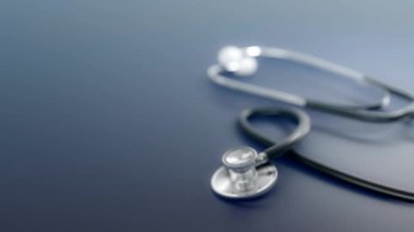 Isolated pan shot of a depth of fields blue medical stethoscope on blue background.