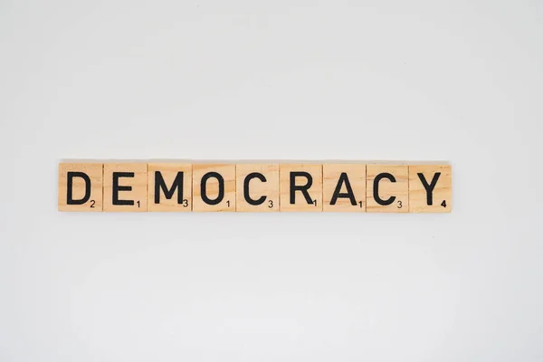 stock image Wooden title spelling the word democracy isolated on a white background