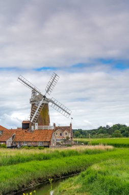 Cley mill in Cley next the Sea in North Norfolk in the UK in portrait orientation clipart