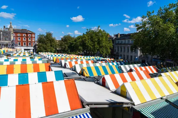 stock image Norwich, UK - August 30 2024: View of the tops of the colourful market stalls in Norwich Market in landscape orientation