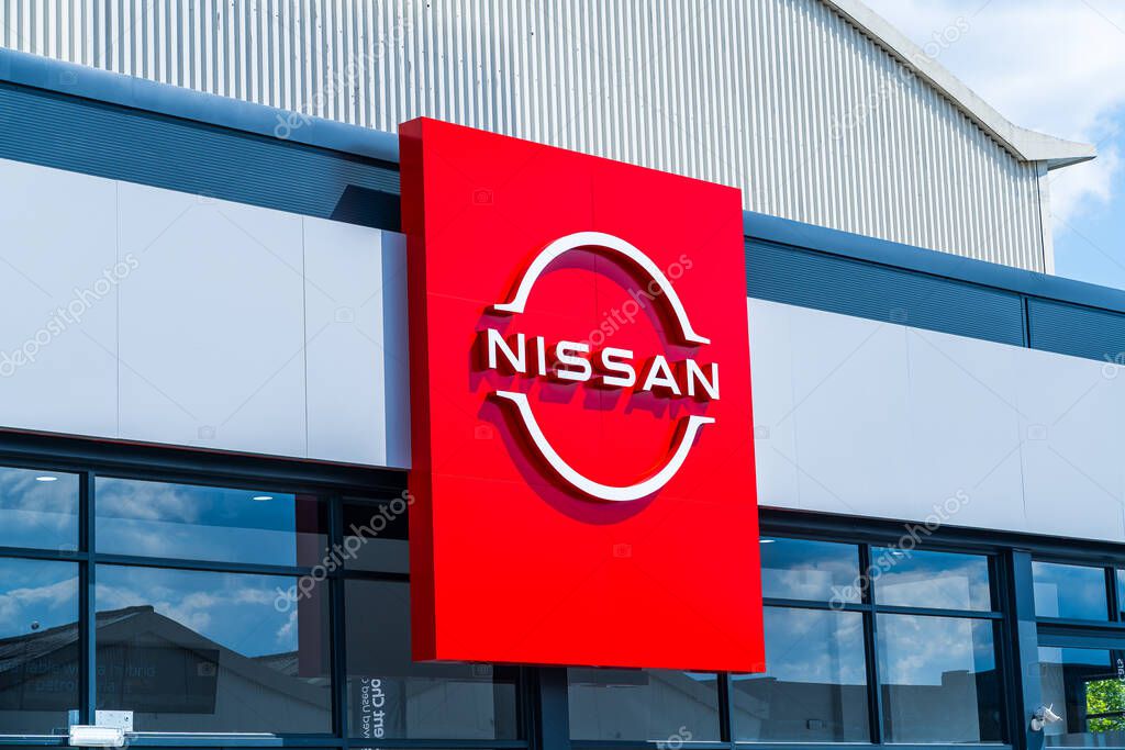 Wolverhampton, UK - May 9th 2025: External signage of Nissan motor company logo and name outside of a car dealership showroom
