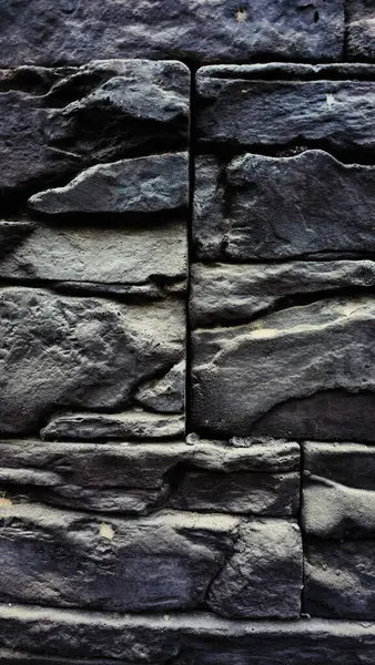 Koyu gri taş duvar arkaplan dokusu kapat