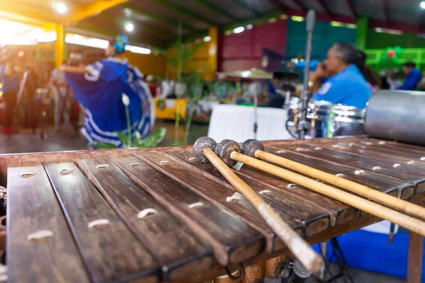 stock image A marimba in the foreground while a dancer in traditional dress performing typical Nicaraguan dances while people watch her