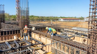 Hispanic workers working on the construction of a stadium