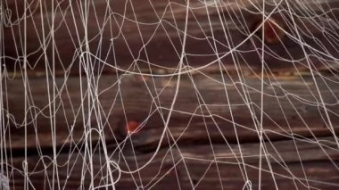 Fishing nets are drying on the wall of an old wooden house. Traditional fishing tools.