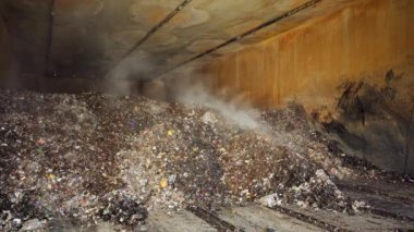 Heap of organic waste at compost recycling station. Bad quality organic waste polluted with plastic garbage at city waste management plant.