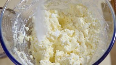 Aşçı, tatlı kurabiye hamuru için malzemelerle karıştırılmış un ekler. Un ekleniyor.