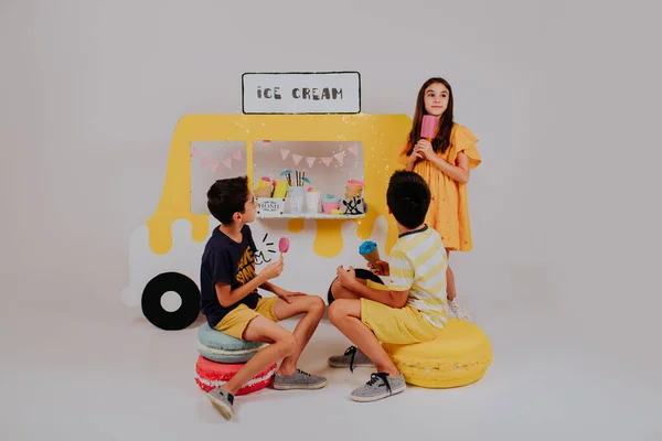 Lovely kids selling ice cream on ice cream truck stand